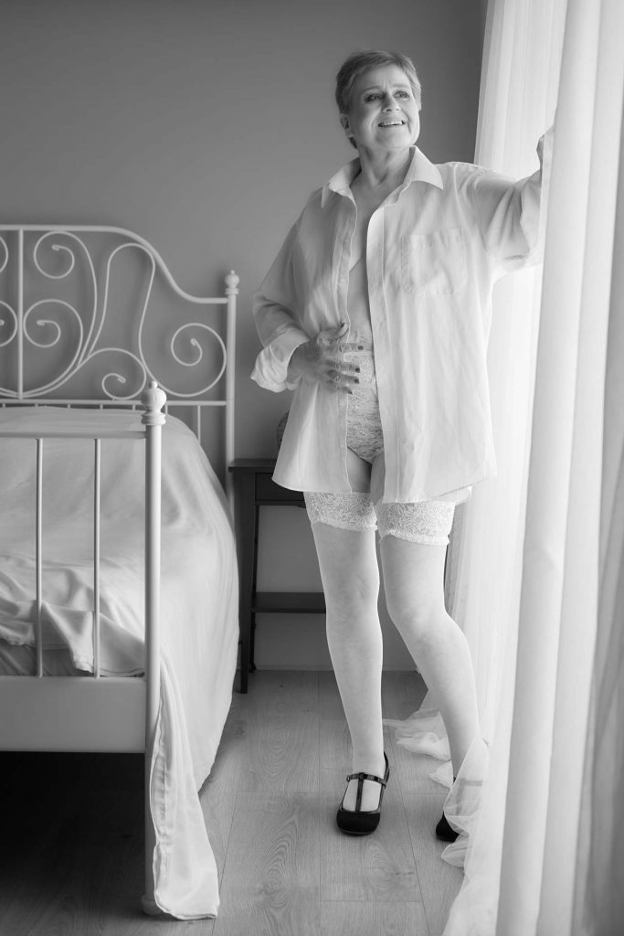 White shirt and stockings by the window in my white sheet photo experience